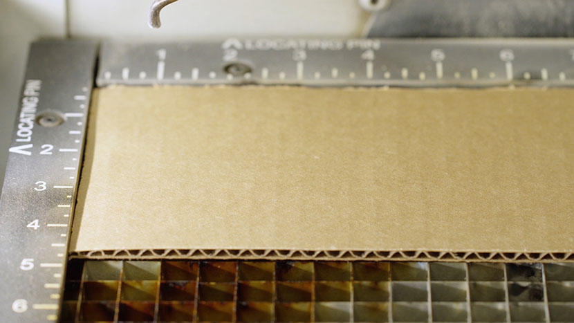 A piece of cardboard in the top-left corner of the Fusion vector cutting grid.