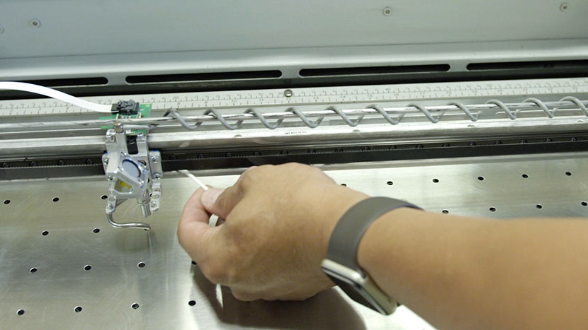 Running a cotton swab along the bottom of the bearing rail.