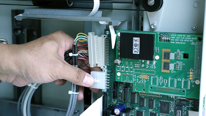 Removing the controller board's middle connector.