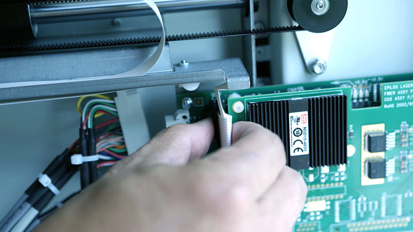 Removing the controller board's top ribbon connector.