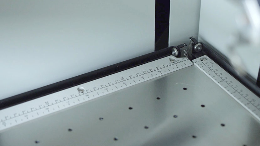 The linear guide rulers along the side and top of the engrvaing table.