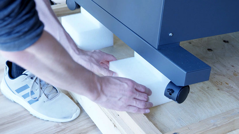 Removing the foam padding underneath the other side of the machine.