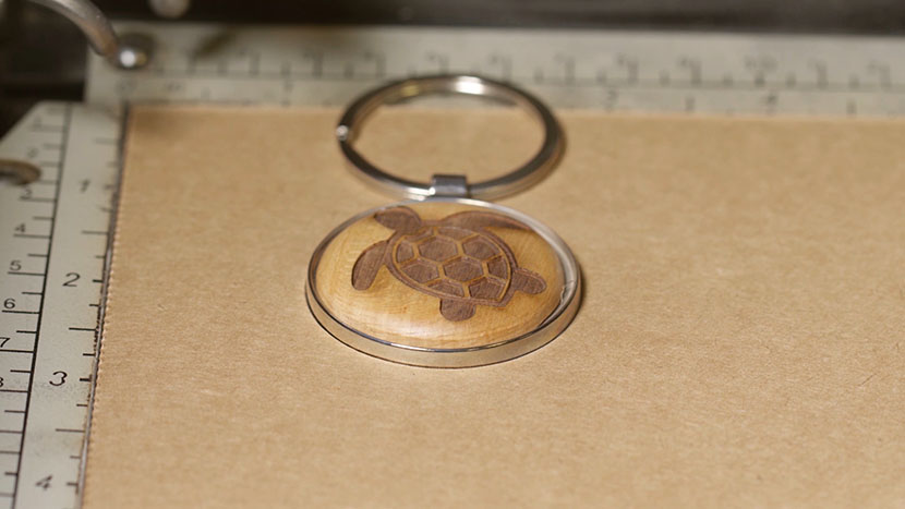 The keychain flipped over in the jig so the un-engraved side is facing up.