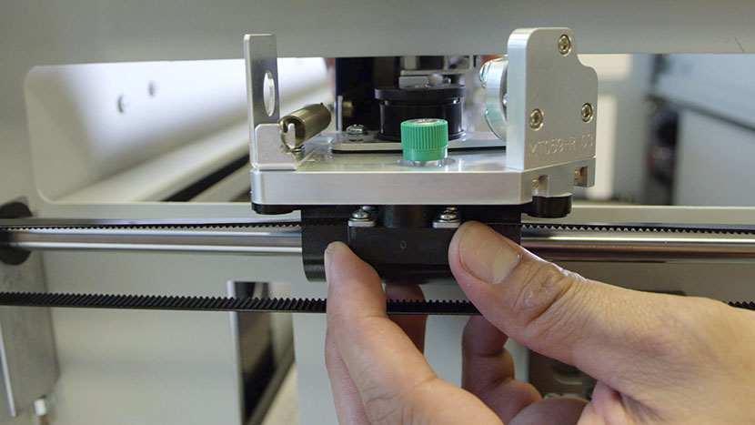 Placing the X-Axis Assembly on its mounting pins.