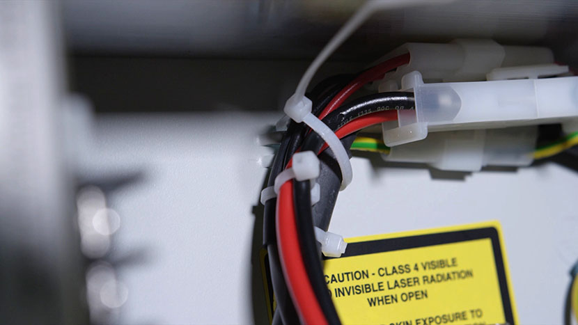 The power supply cords secured in a zip tie.