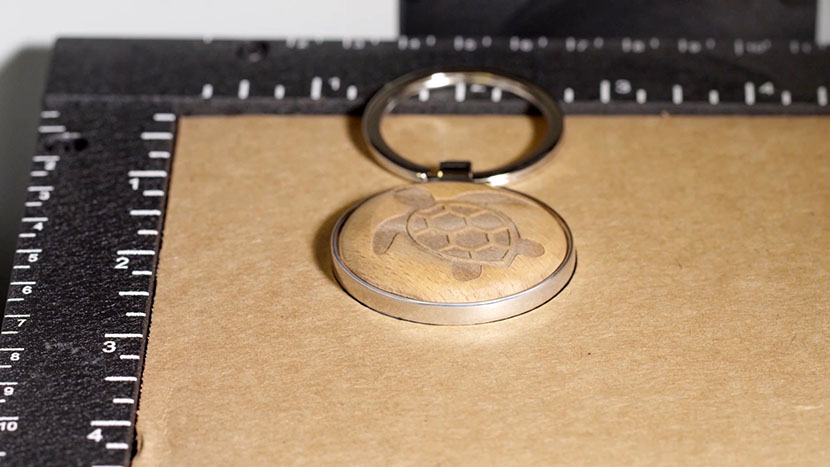 The keychain flipped over in the jig so the un-engraved side is facing up.